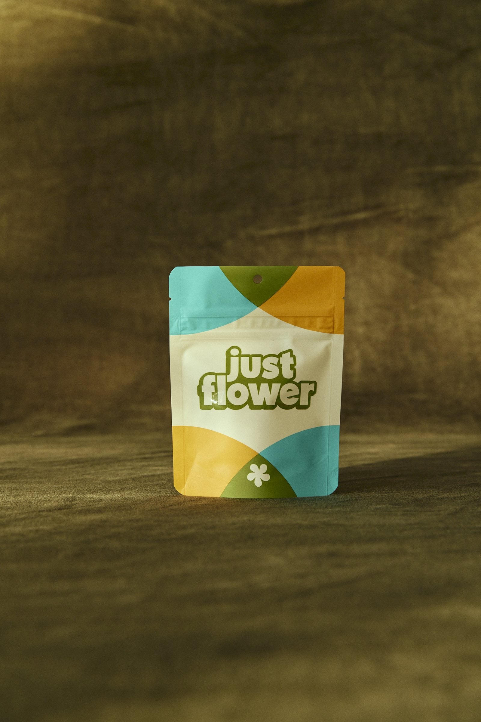 Just Flower cannabis package in low light against a dark backdrop